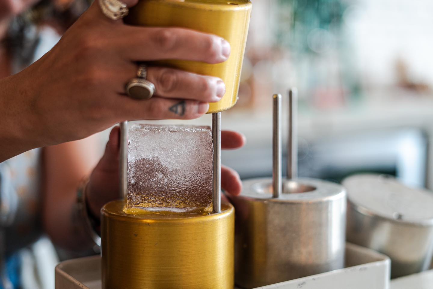 A bartender at The Public House in Bay City making a drink called "Moon Over Mexico"