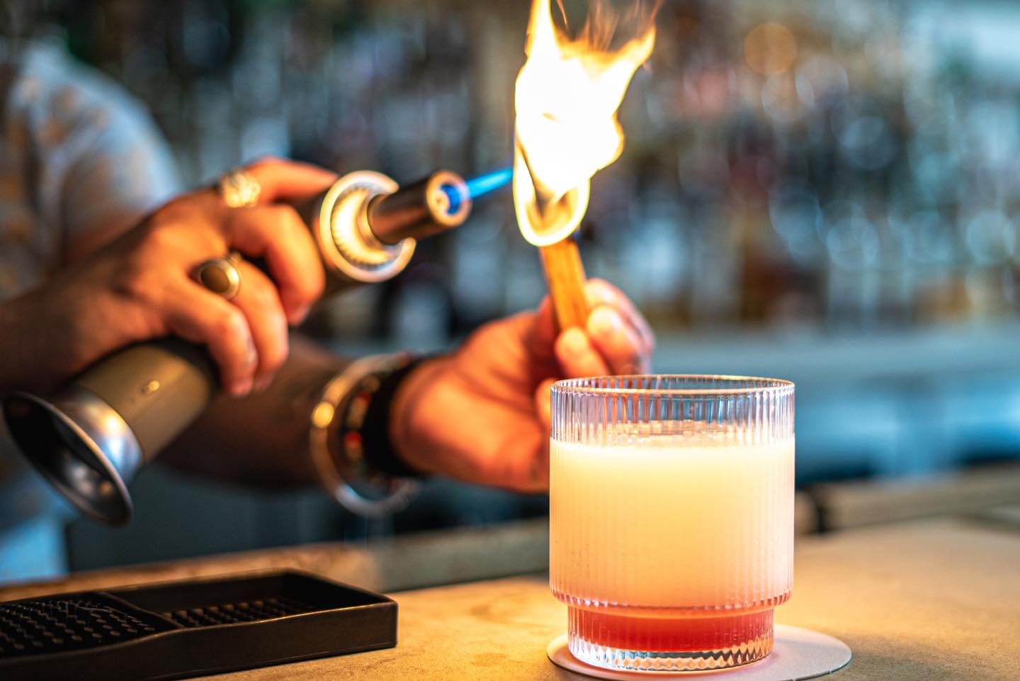 A bartender at The Public House in Bay City making a drink called "Ghost in the Machine"
