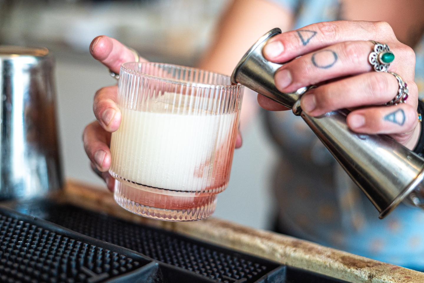 A bartender at The Public House in Bay City making a drink called "Ghost in the Machine"
