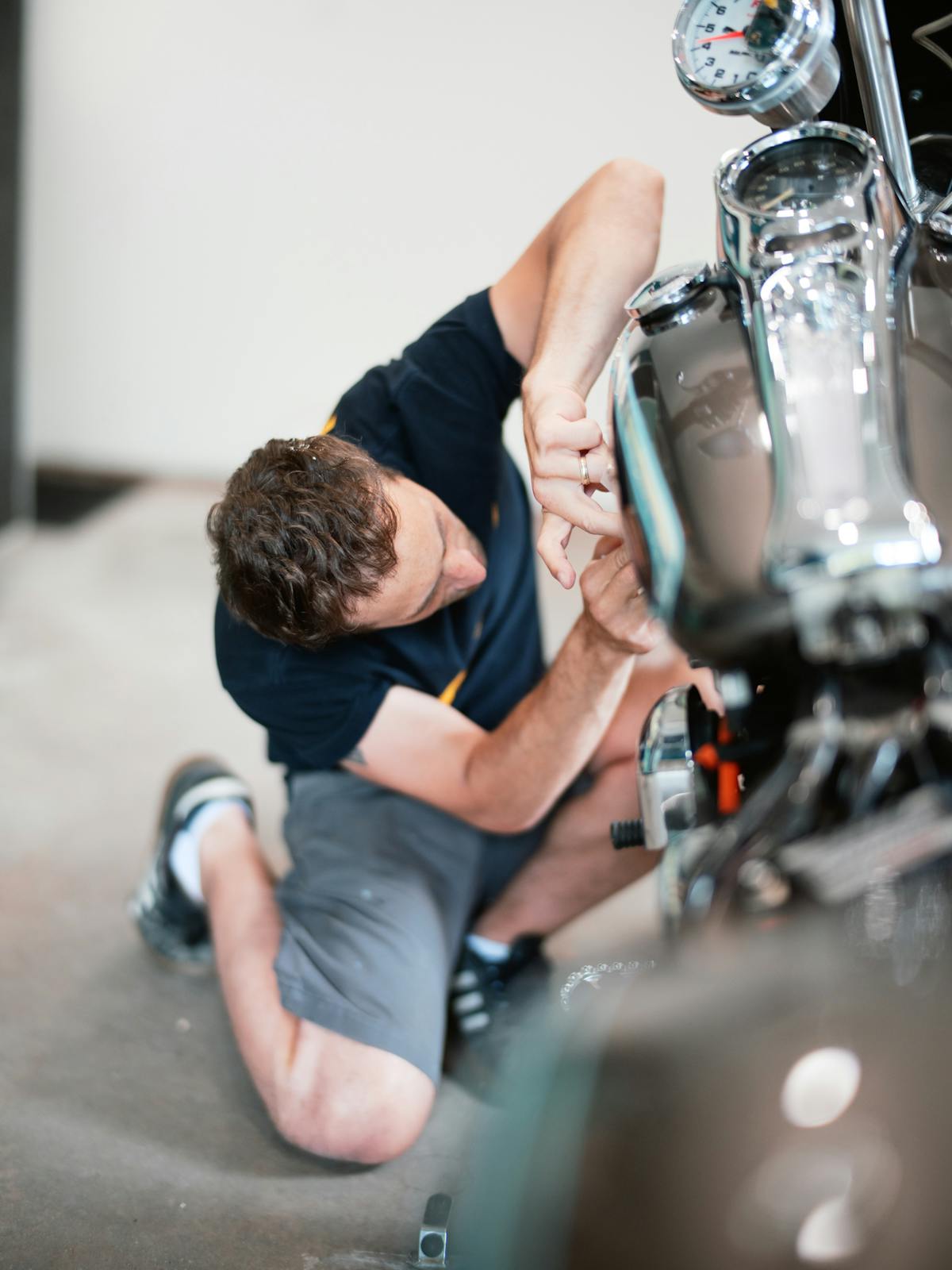 Justin Stilson, owner of Stilson Sign and Custom painting a motorcycle