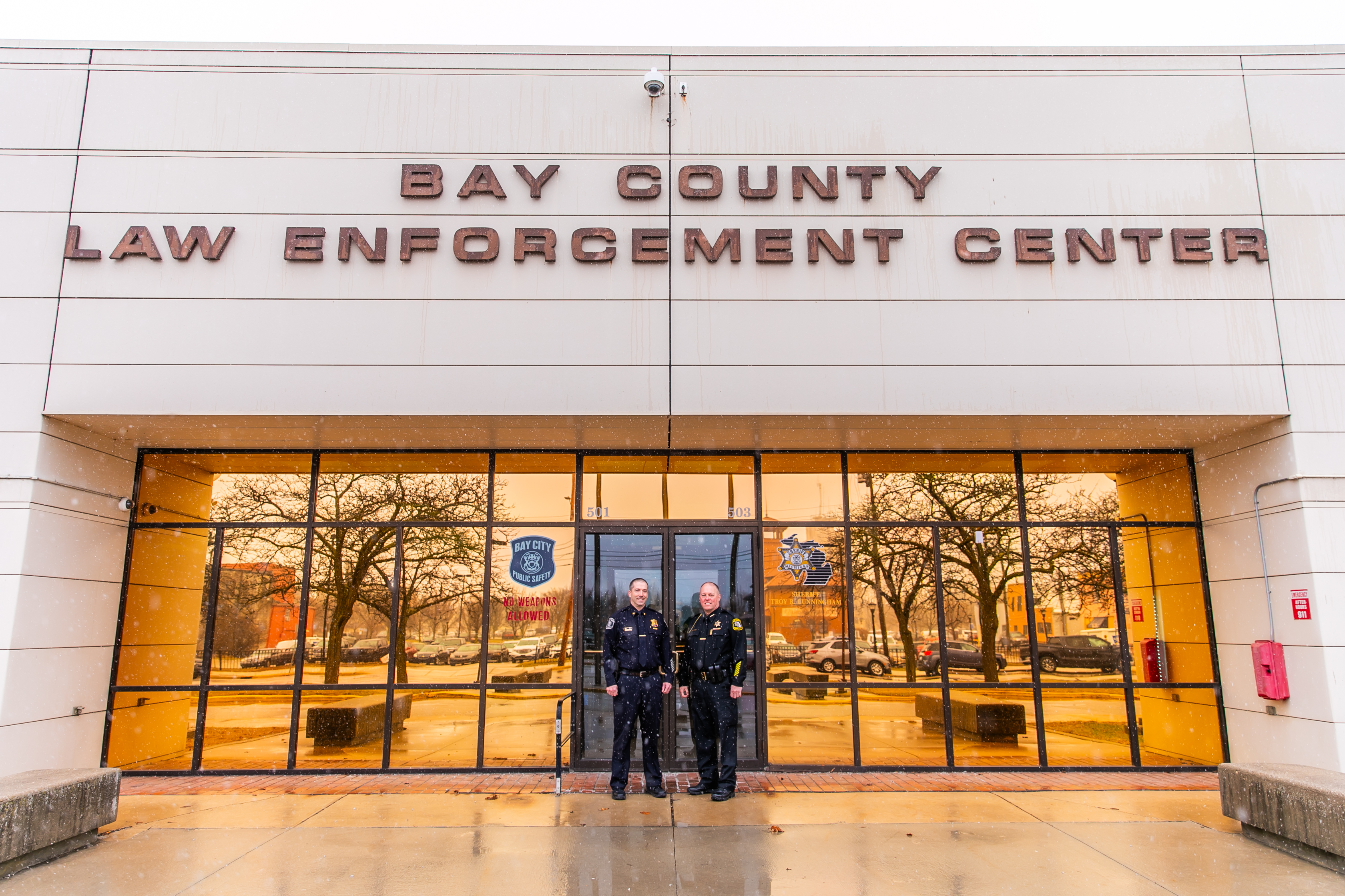 Troy Cunningham, Sheriff of Bay County and Caleb Rowell, Public Safety Director, Bay City Department of Public Safety in front of building in Bay City, Michigan. 
