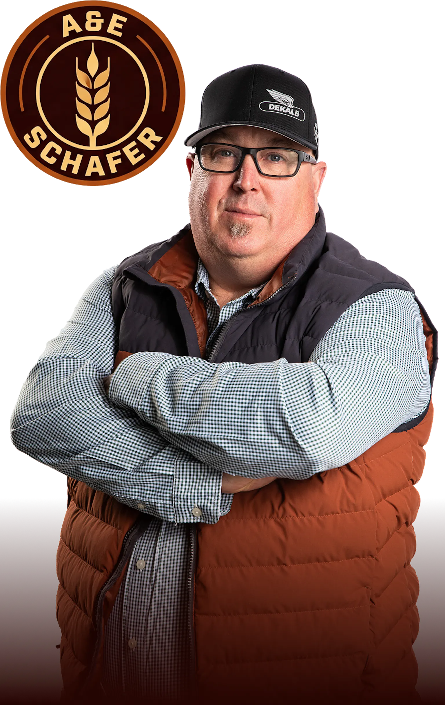 Circular badge with a wheat stalk icon in the center, surrounded by the words “A&E Schaefer” in a brown and gold color palette beside a photo of Ed Schafer with his arms crossed