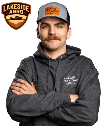 Shield badge showing a lake with shoreline and horizon lines, labeled “Lakeside Agro” in brown and tan beside a photo of Jay Bindig with his arms crossed