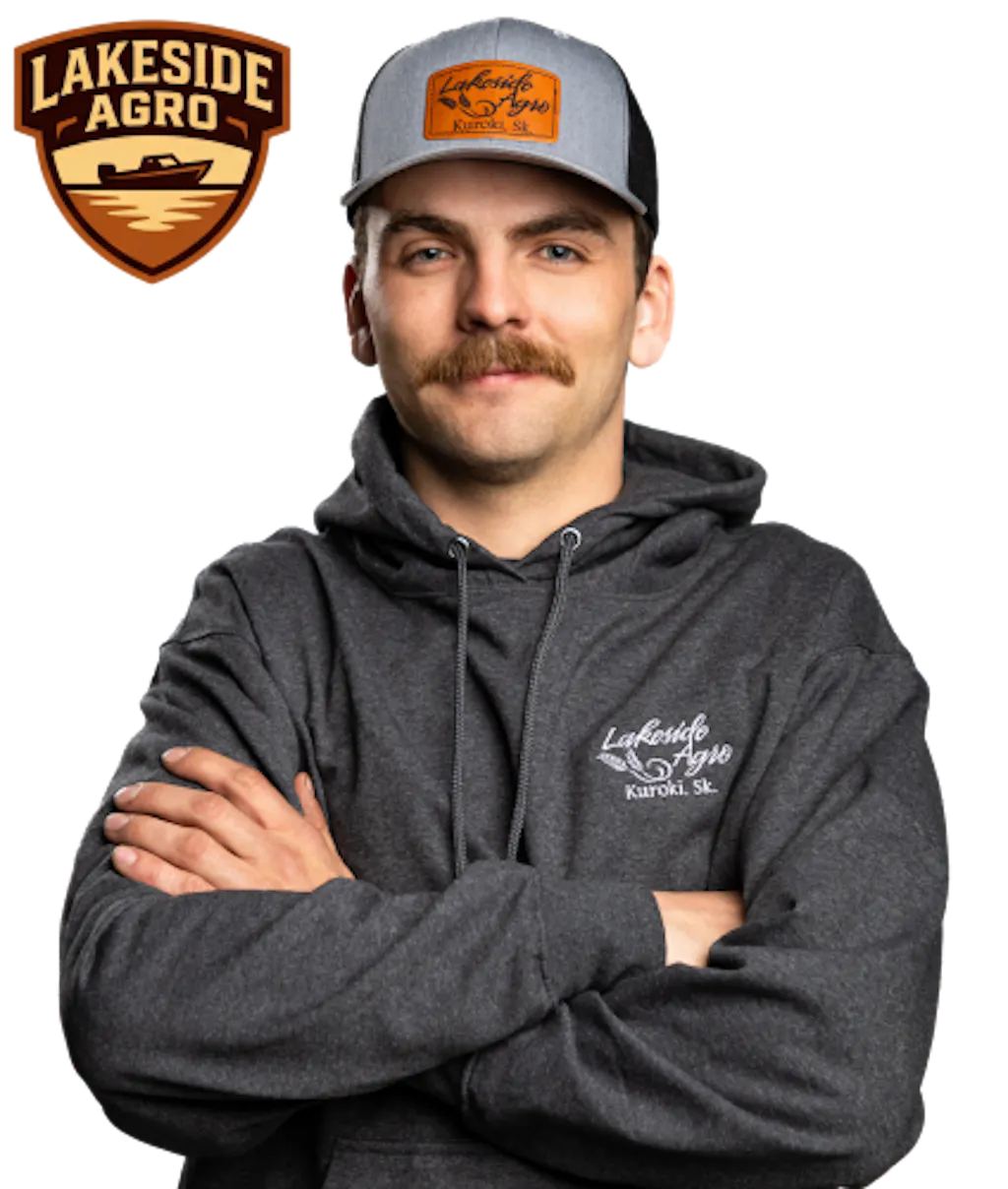 Shield badge showing a lake with shoreline and horizon lines, labeled “Lakeside Agro” in brown and tan beside a photo of Jay Bindig with his arms crossed