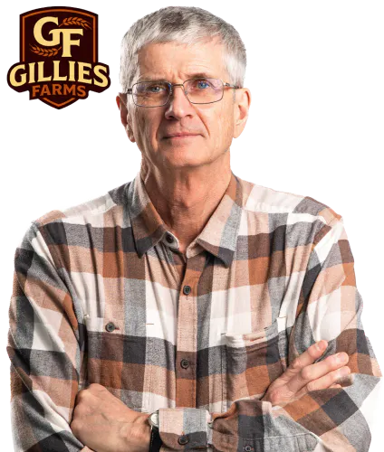 Shield badge with stylized “GF” lettering and a wheat head above, labeled “Gillies Farms” in warm earth tones beside a photo of Bryan Gillies with his arms crossed