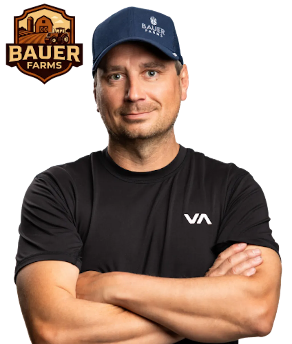 Shield badge with a barn and silo illustration at the top and “Bauer Farms” in bold lettering, using warm brown and orange hues beside a photo of Chris Bauer with his arms crossed