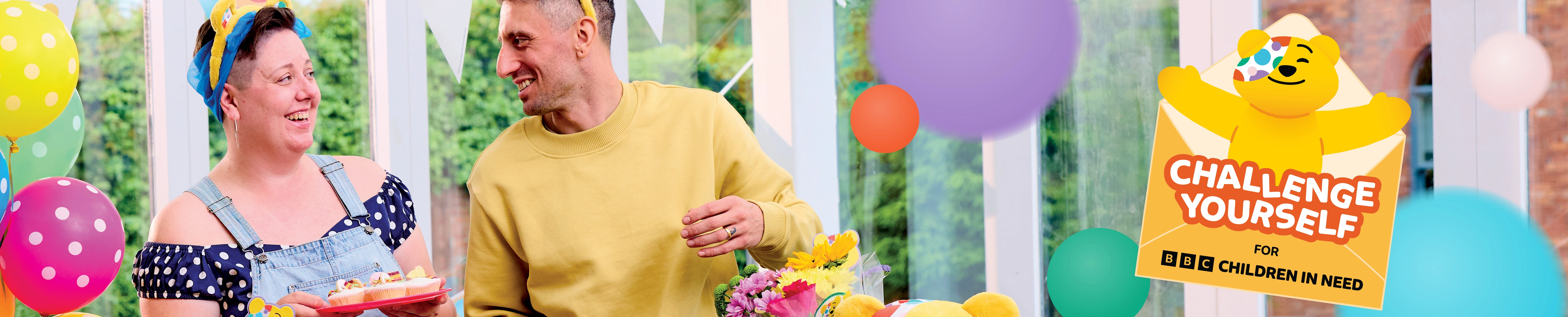 Challenge Yourself site banner with two smiling participants setting up a colourful bake sale.