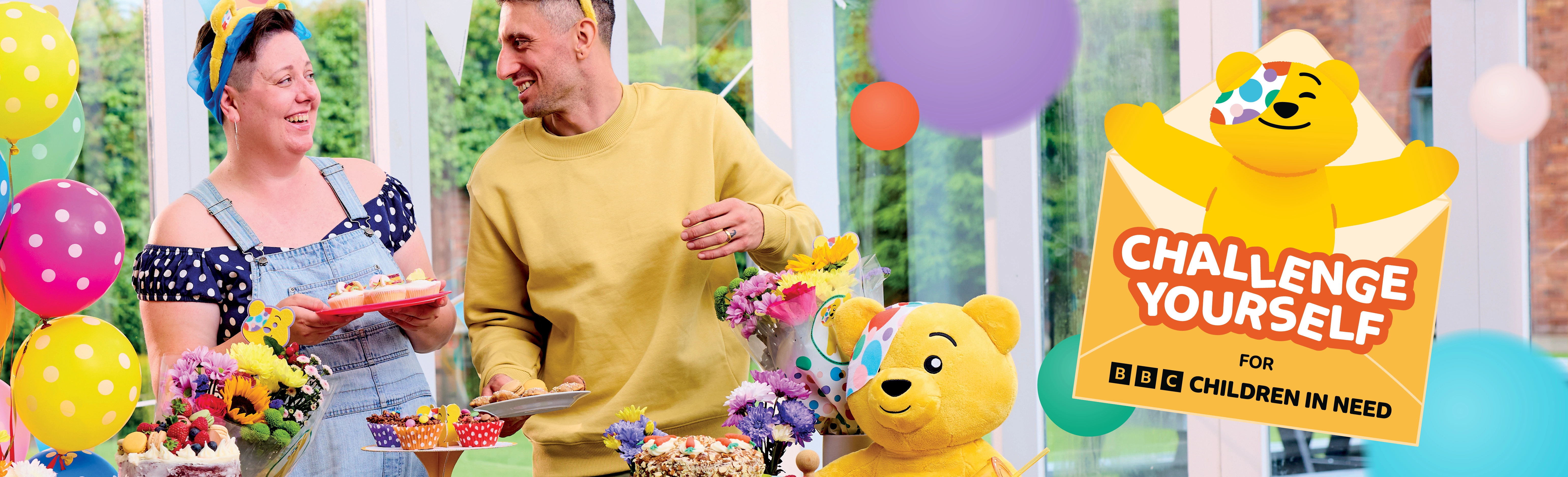 Challenge Yourself site banner with two smiling participants setting up a colourful bake sale.