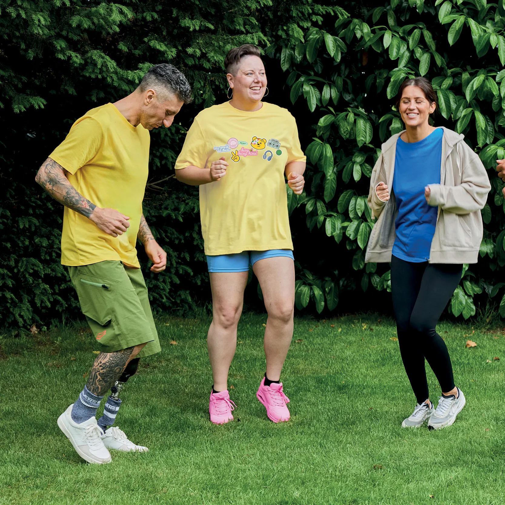 Group of adults jumping around outside. 