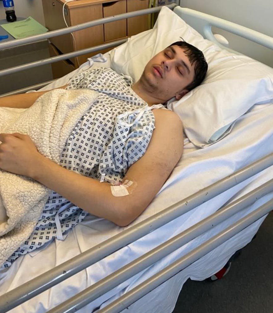 Brandon laying in hospital bed sleeping