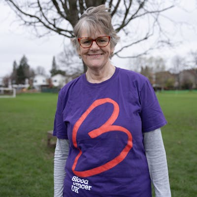 Photo of a woman smiling outside in her Blood Cancer UK t-shirt.