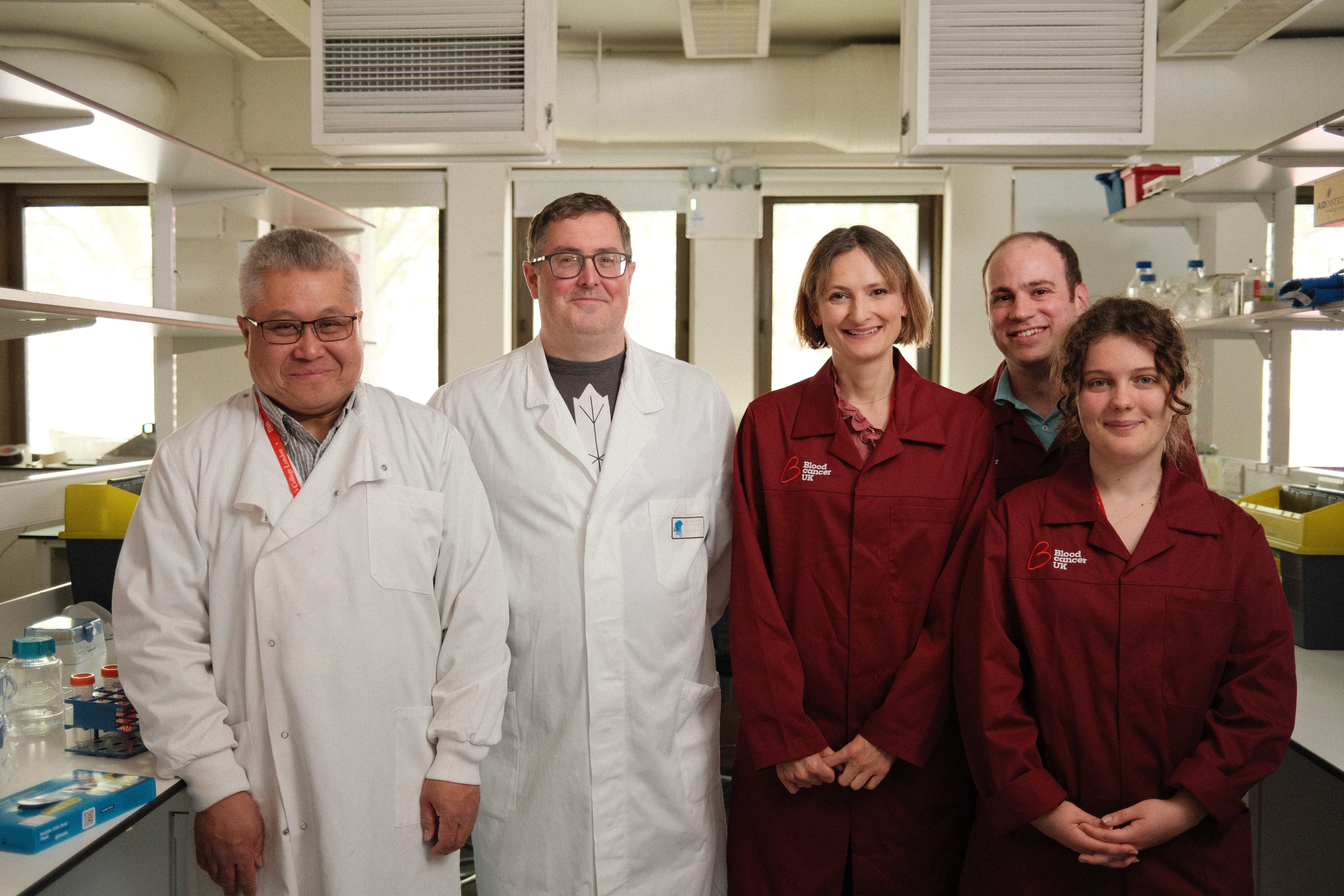 PHD students smiling in a lab.
