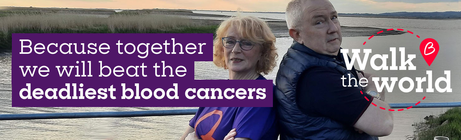 Two Walk the World participants standing by a riverside, supporting Blood Cancer UK’s fight against blood cancer.
