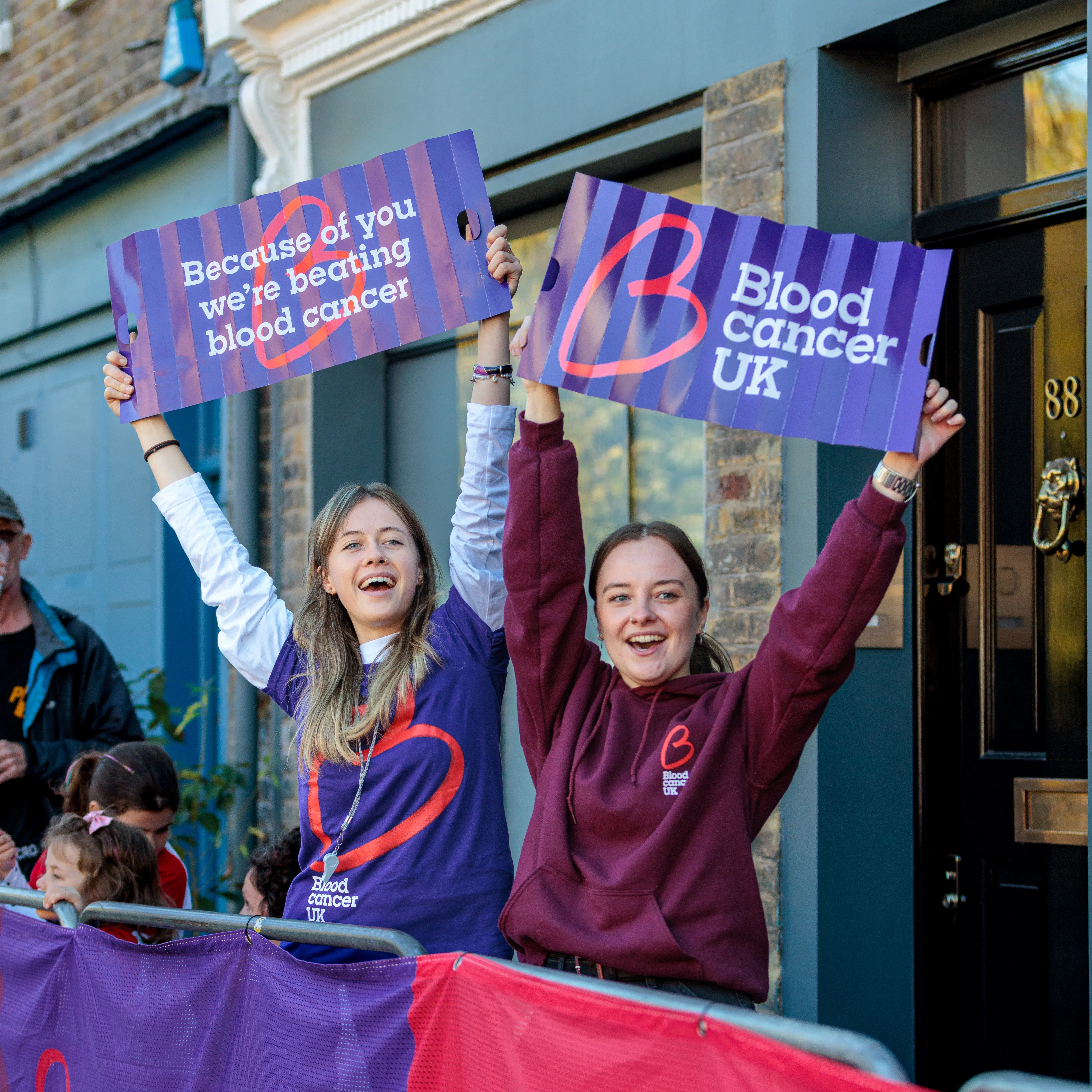 Supporters holding Blood Cancer UK signs at a Walk the World event.