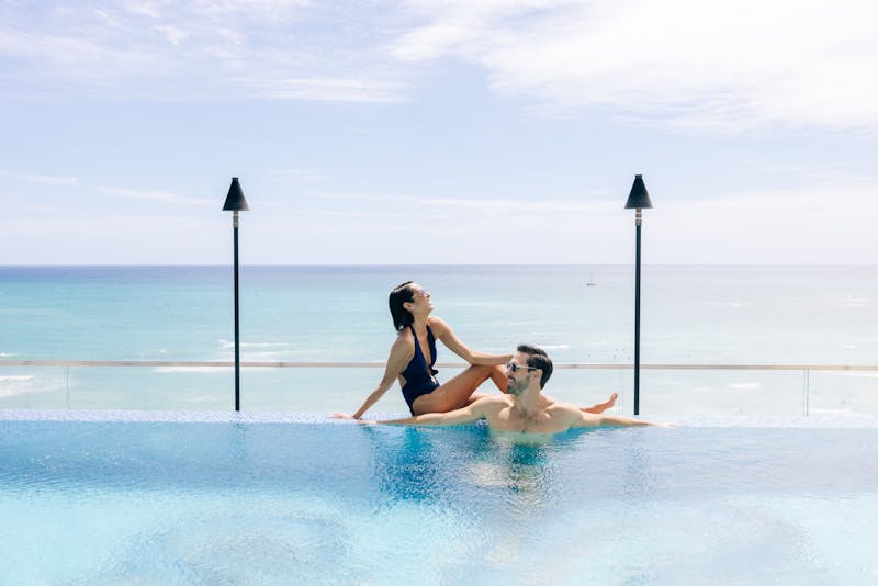 couple at infinity pool with an ocean view