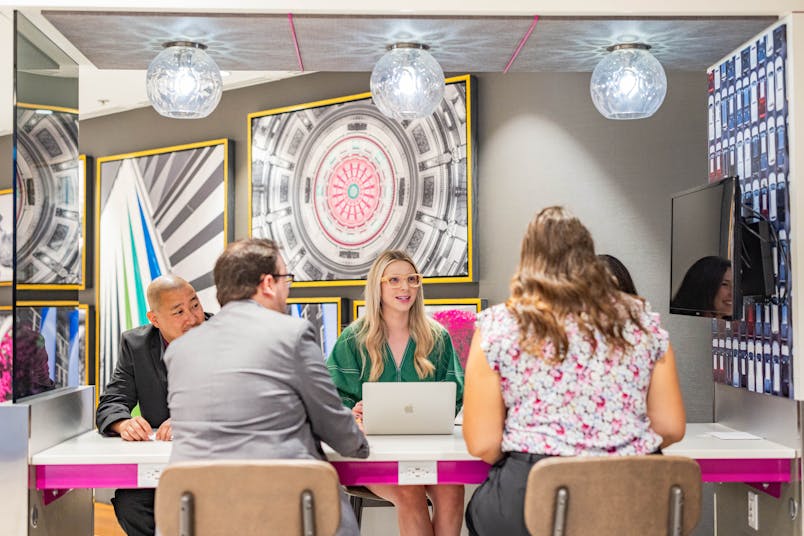 group of people sitting at a table working collaboratively 