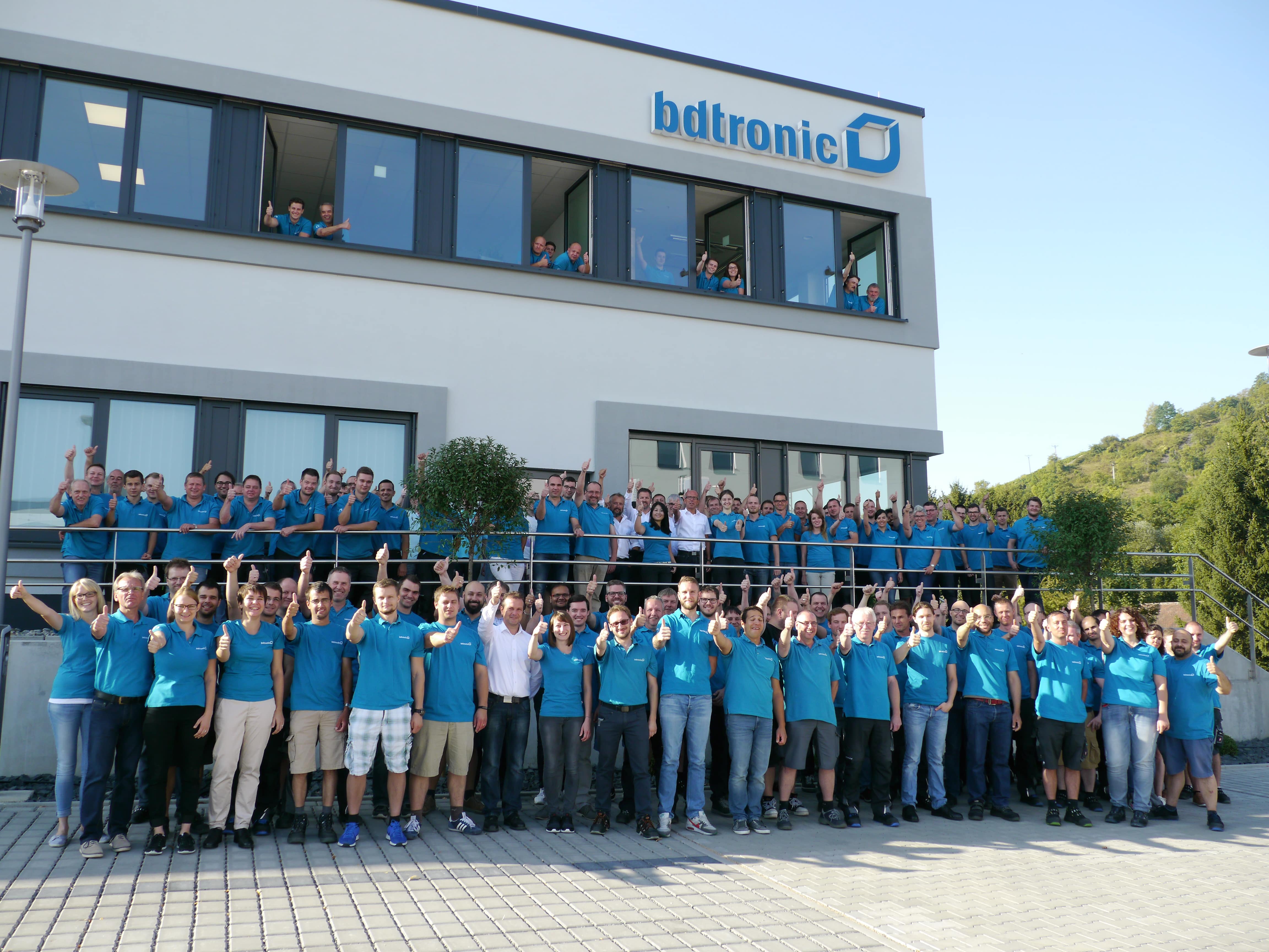 bdtronic employees in front of the company building in Weikersheim