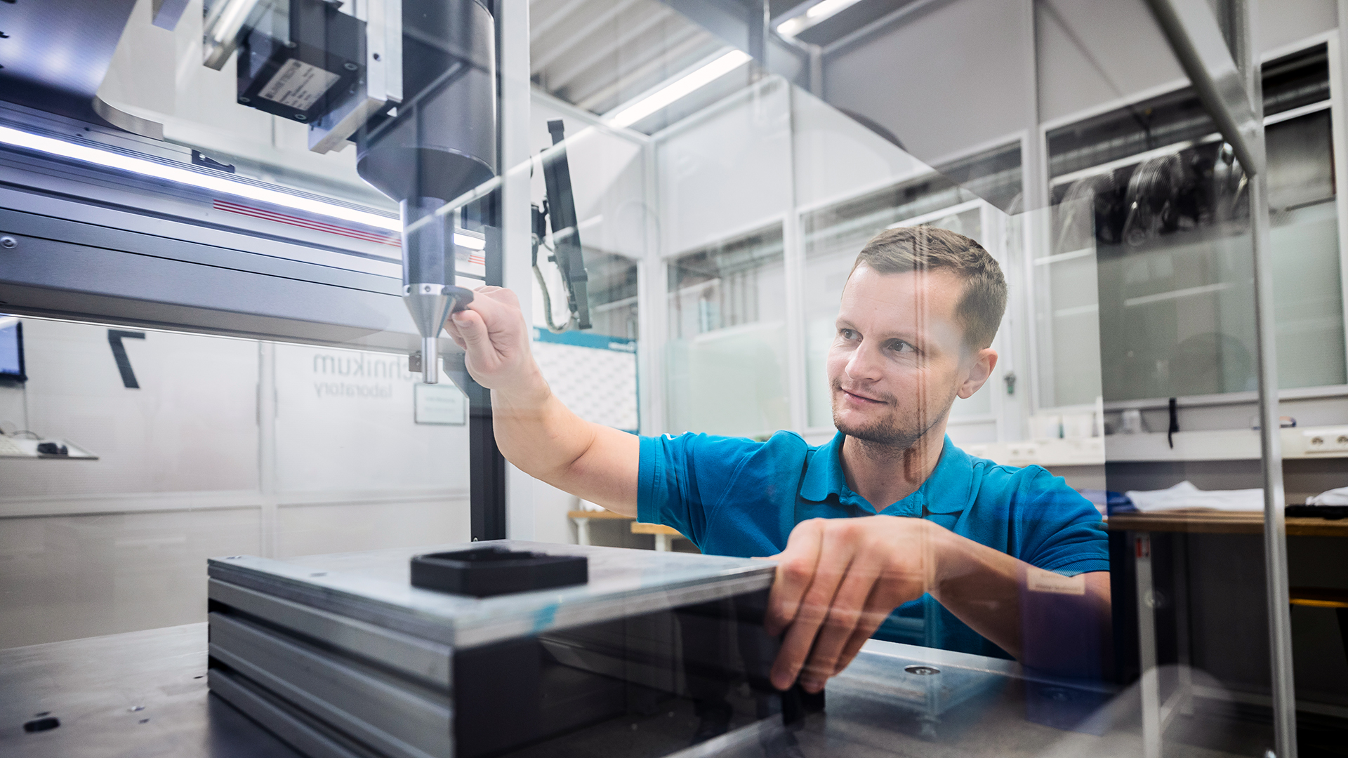 Person working on a machine with a wrench