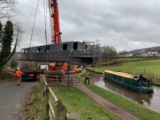 lifting the steel shell of beacon park boat falcon into the mon and brec canal
