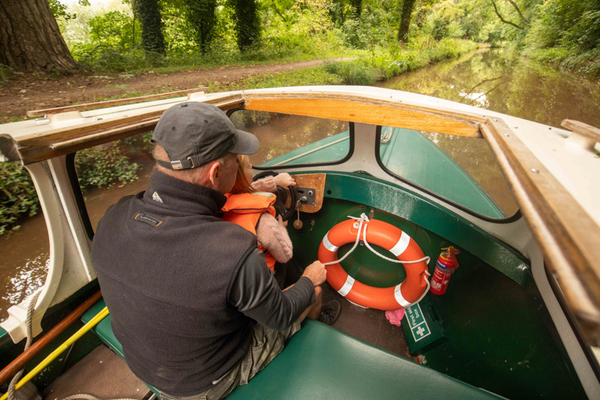 man and child driving a beacon park boats day boat