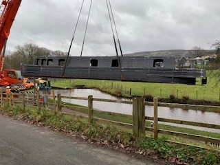 lifting the steel shell of beacon park boat falcon into the mon and brec canal