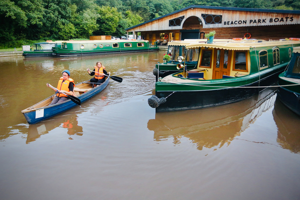 a beacon park day boat alongside a canal boat at beacon park boats' base of llangattock wharf