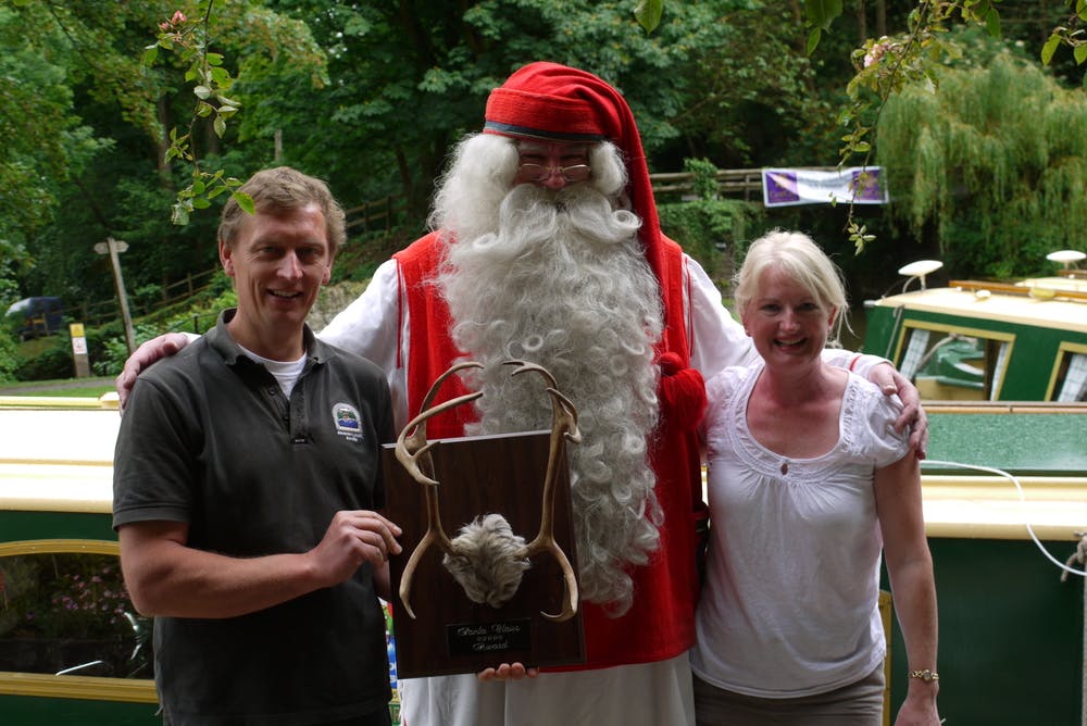 Alasdair and someone else standing with Santa 