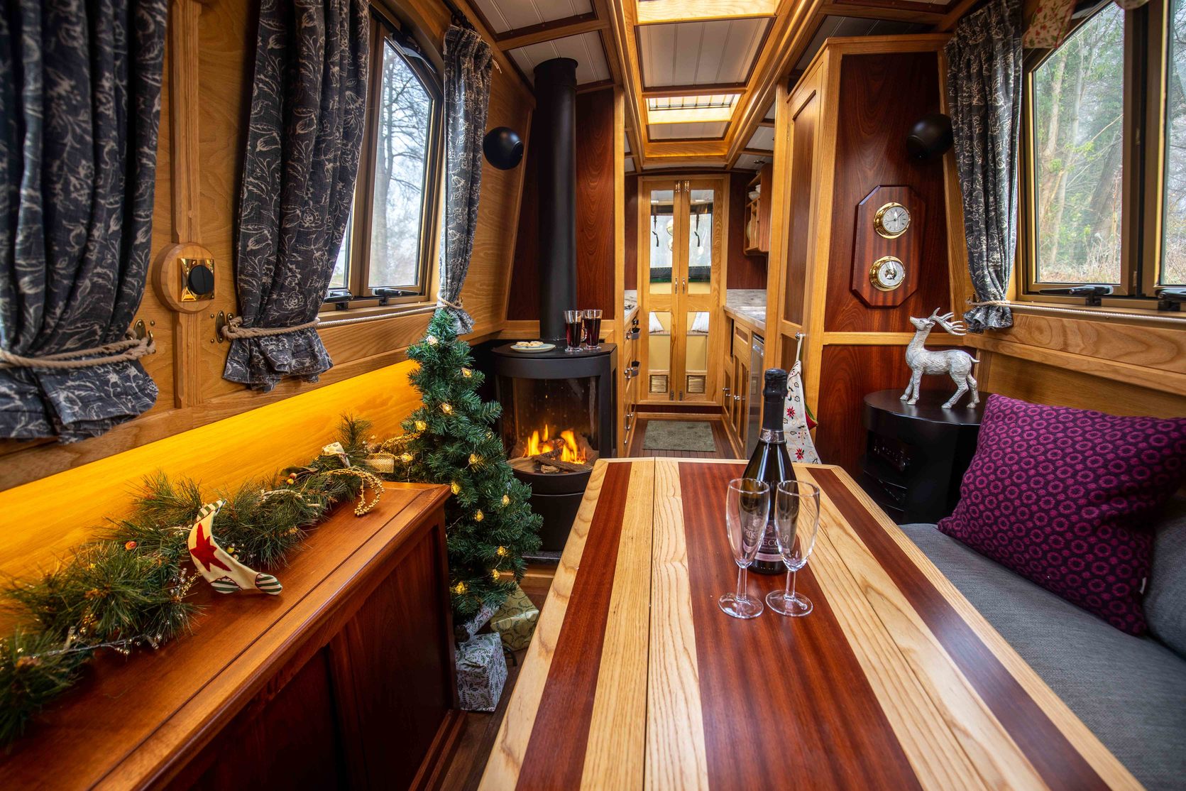 inside of a Christmas decorated beacon park boat with prosecco on the table