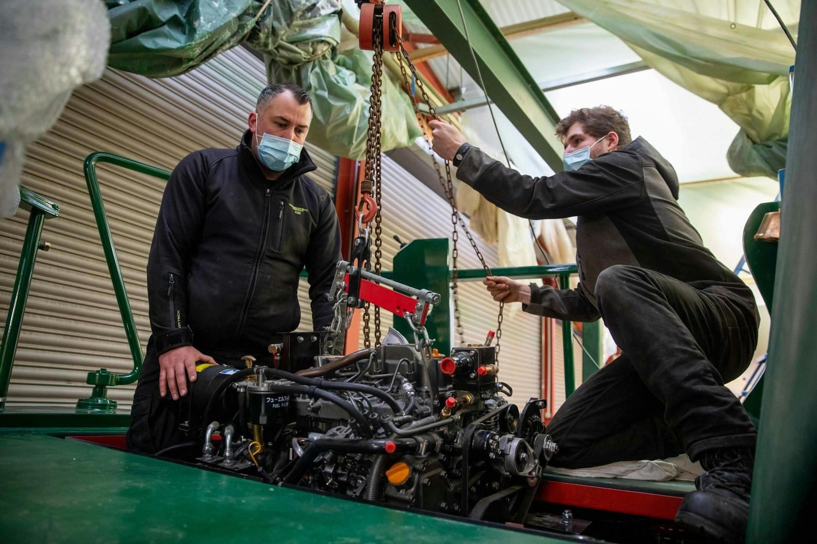 Image of an engine being installed on the Falcon Boat