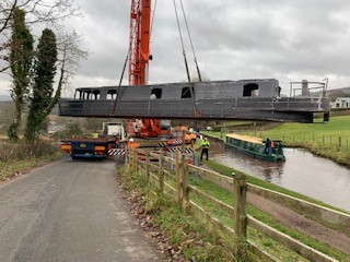 lifting the steel shell of beacon park boat falcon into the mon and brec canal