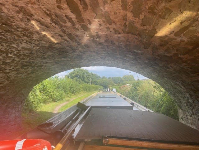 a beacon park boat going under a tunnel on the mon and brec canal