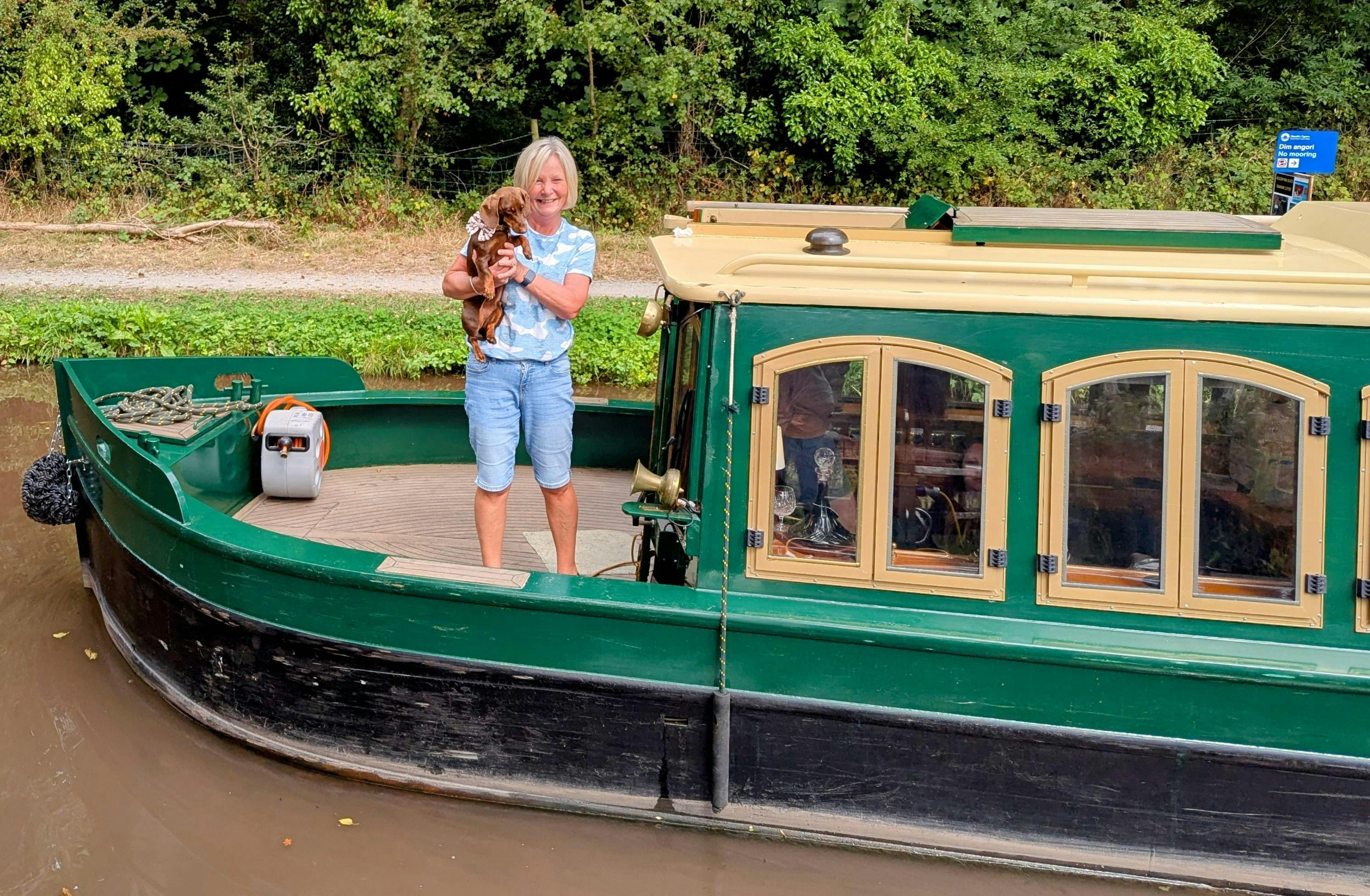 a guest and their dog aboard a beacon park boat