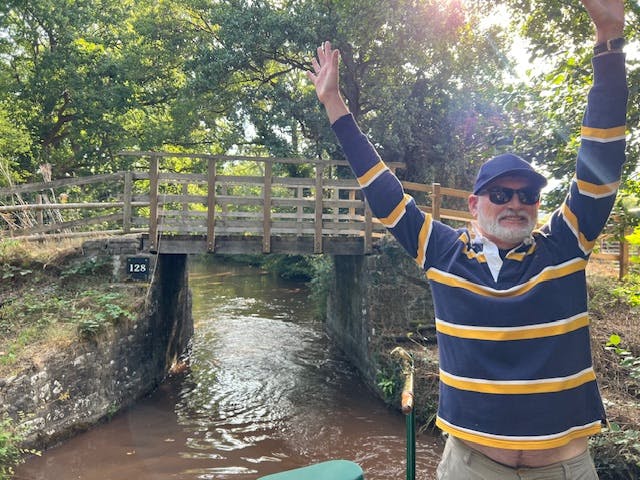 guest enjoying his time at the tiller of beacon park boat wren