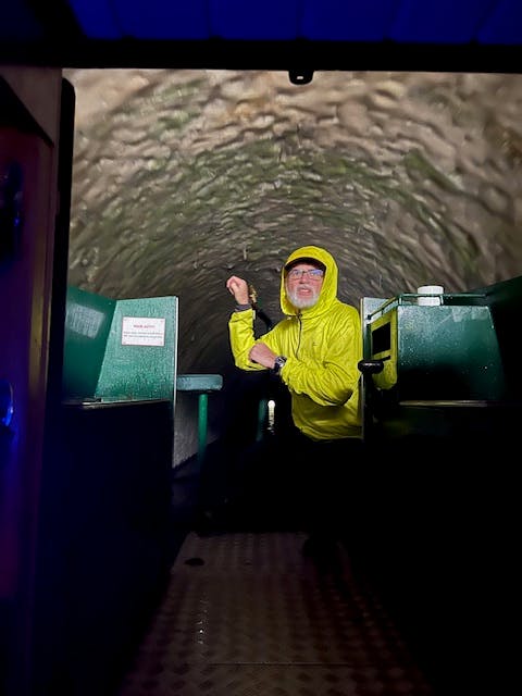 guest aboard beacon park boat wren going through a tunnel