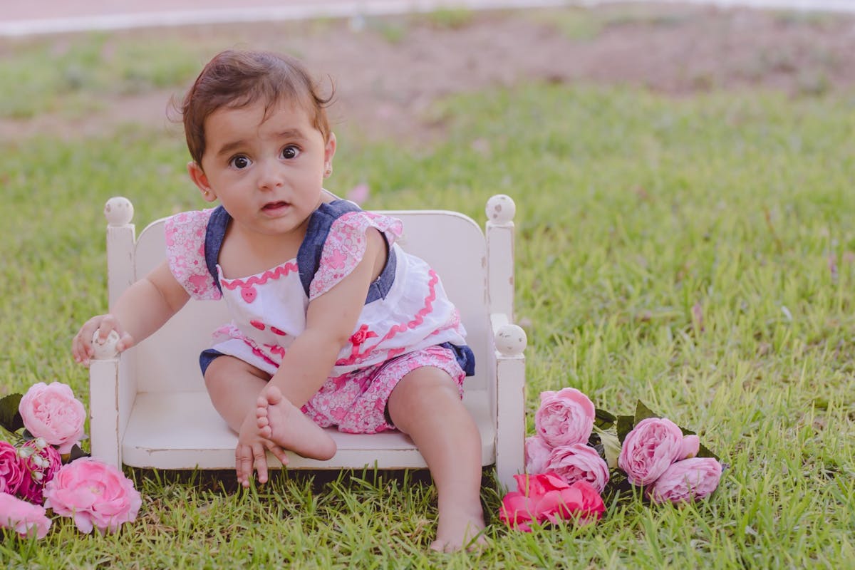 Baby girl sitting on a chair