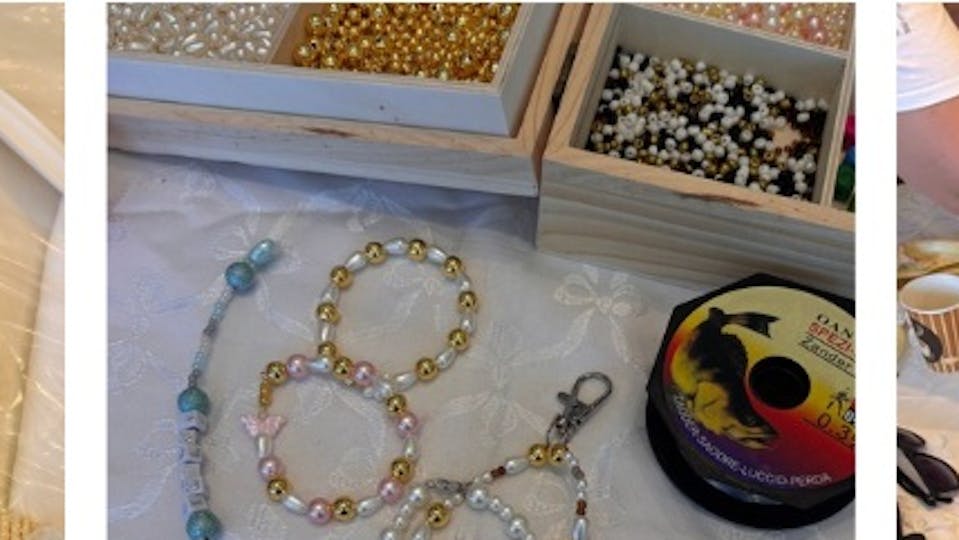 bracelets and pearls on a white table cloth