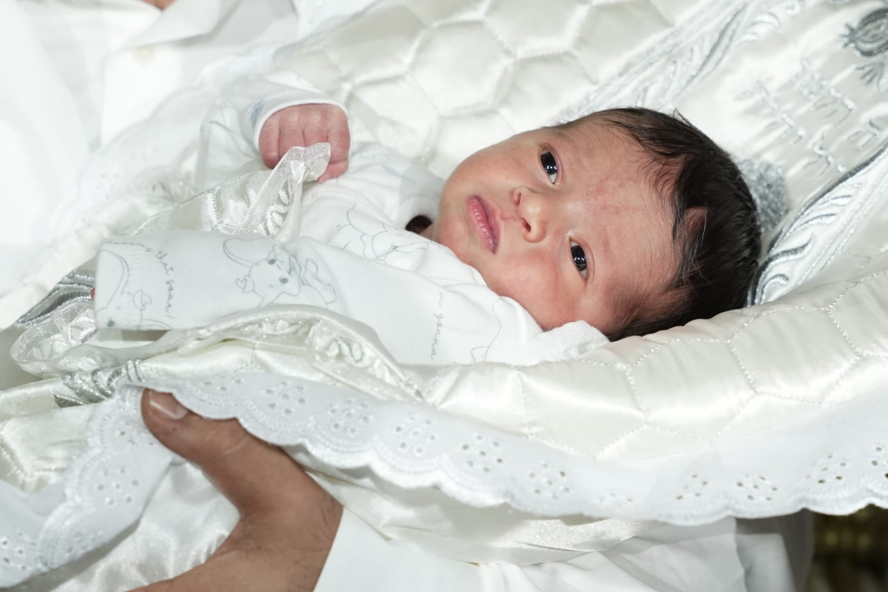 baby Michael in white clothes and blanket