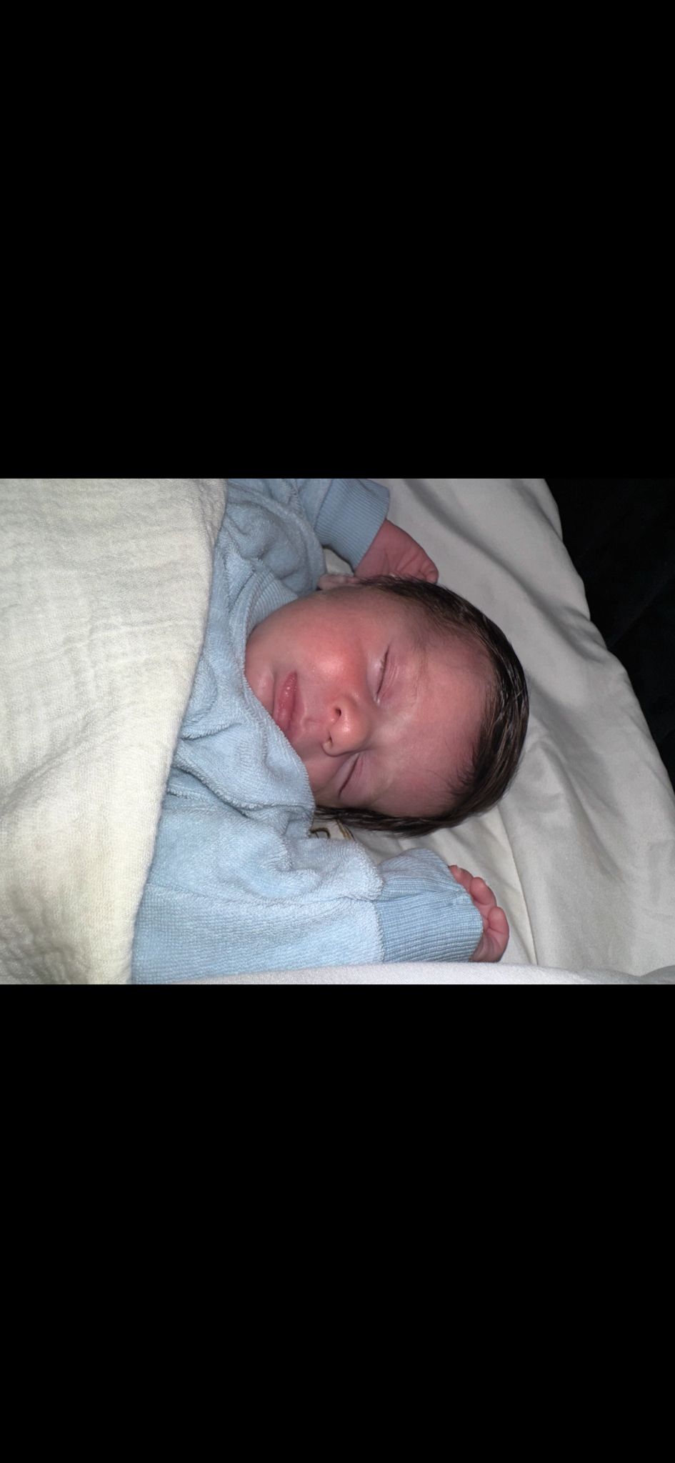baby Imri David in light blue sweater, sleeping peacefully