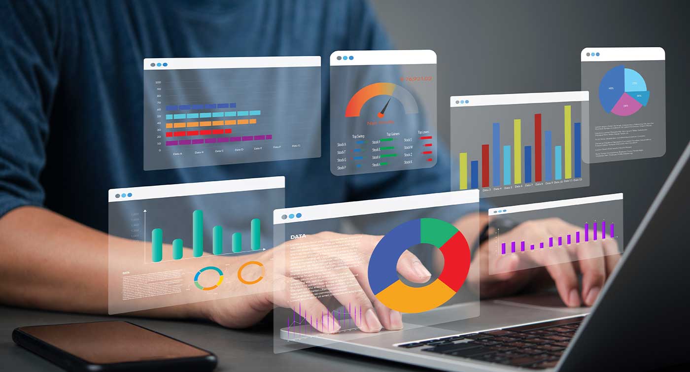 Graphs reflecting business financial metrics coming out of a laptop screen.