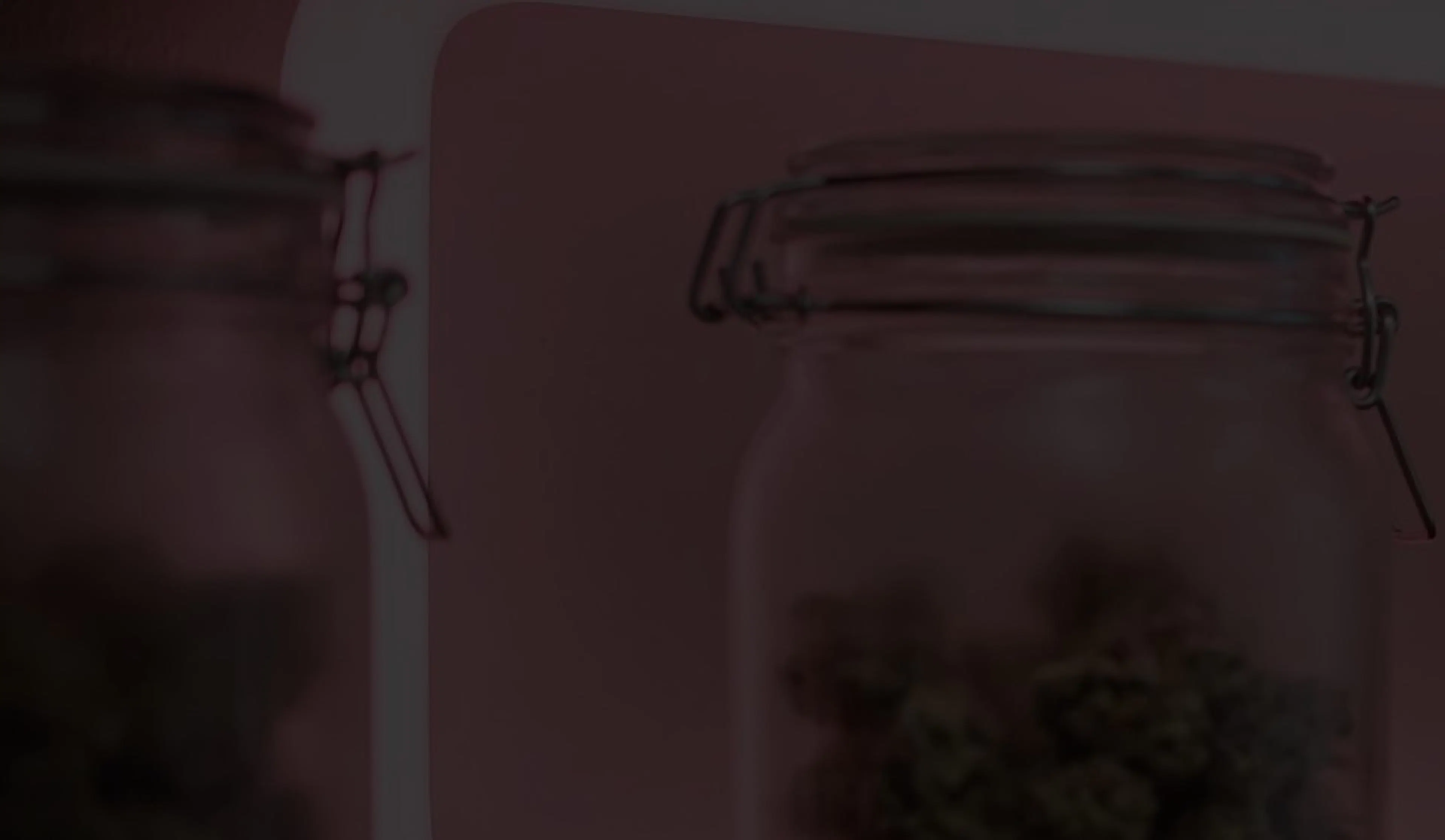 Cannabis jars on a pink neon lit shelf with the Beleaf wordmark
