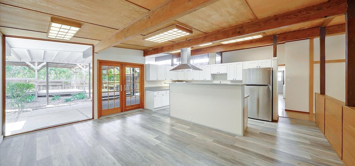 A photo of a kitchen renovation with new flooring and layout to open up a home