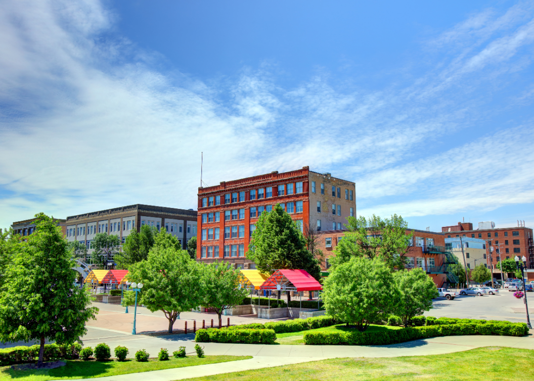 A photo of a neighborhood in North Dakota with buildings and trees