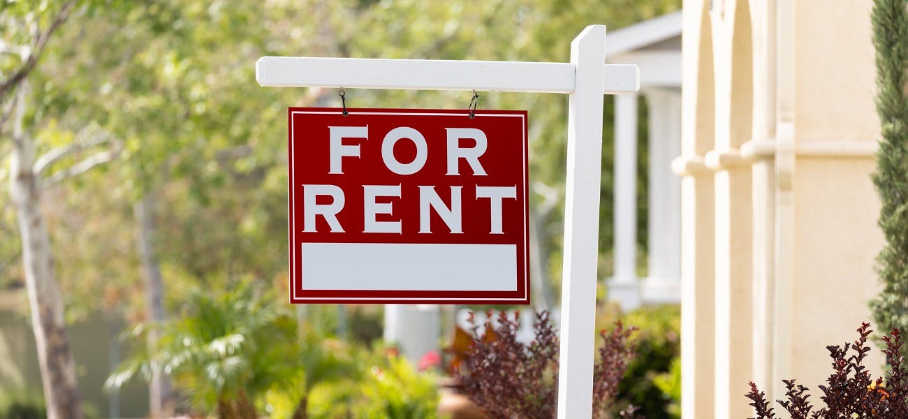 A "For Rent" sign outside a home to decrease tenant vacancy and turnover 