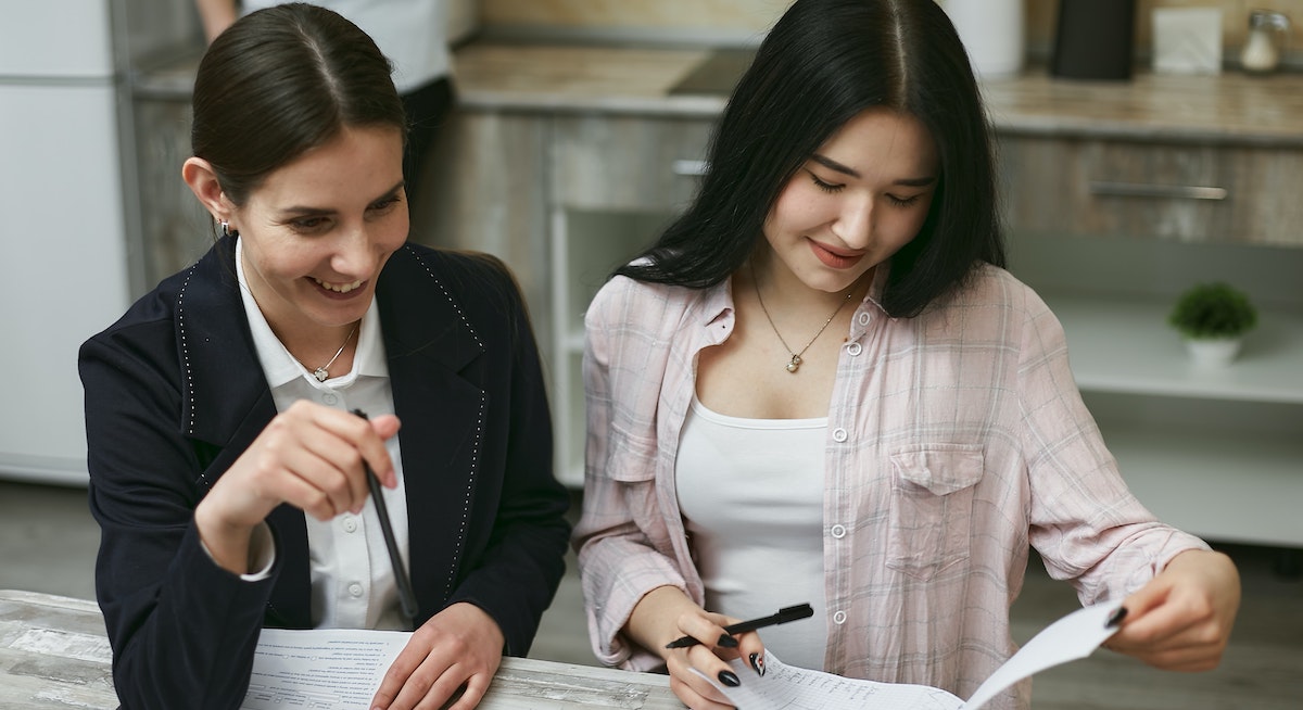 A young woman examines financing options for investment properties with a mortgage broker