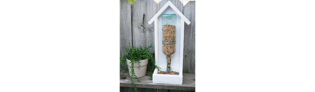A homemade bird feeder made from a wine bottle