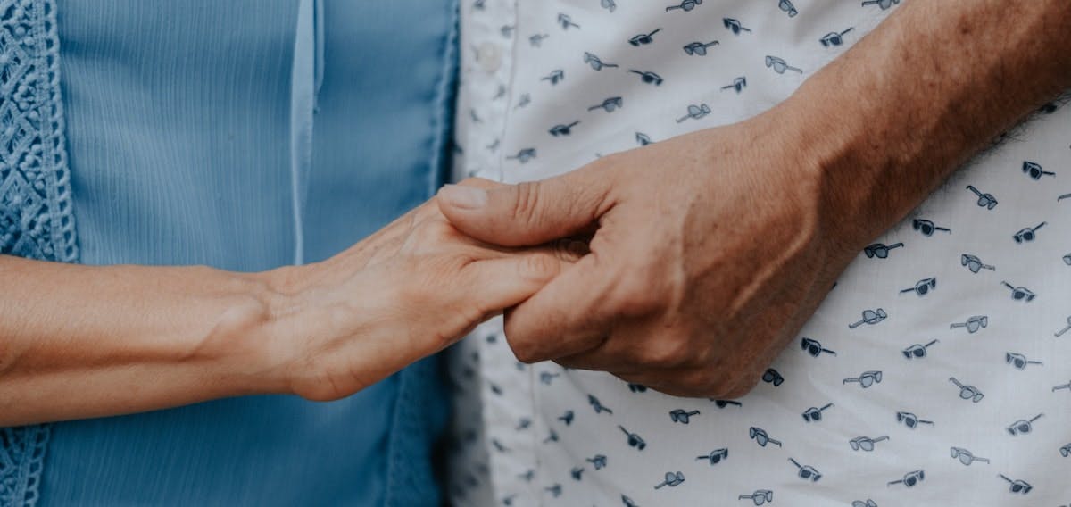 A close up image of a couple holding hands. Inheriting a property can be an emotional time but there are also tax considerations to be aware of before deciding what to do with the family home.