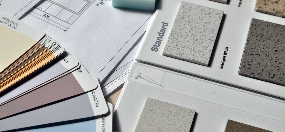 An image of paint and countertop samples for a home renovation. If you're looking for the best renovation companies in the US, here are 5 national experts to consider