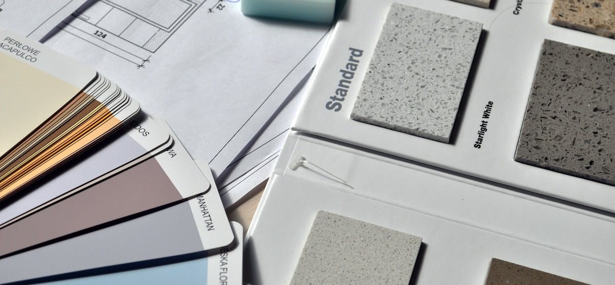 An image of paint and countertop samples for a home renovation. If you're looking for the best renovation companies in the US, here are 5 national experts to consider