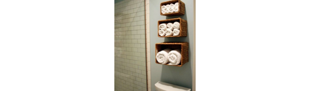 3 baskets of towels mounted on bathroom wall