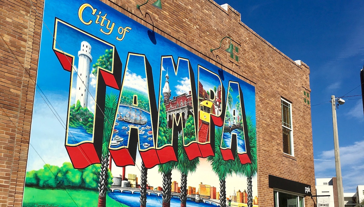 An image of a mural wall that says "City of Tampa", located in Tampa Florida. Learn more about investing in real estate in Tampa. 